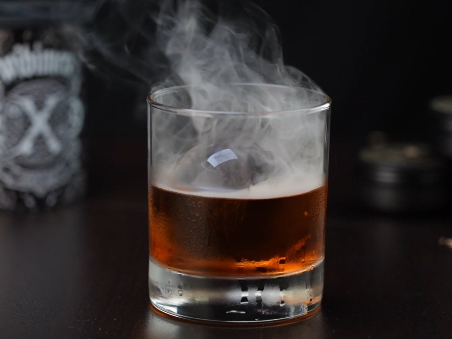 Smoked whiskey served over a large clear ice sphere