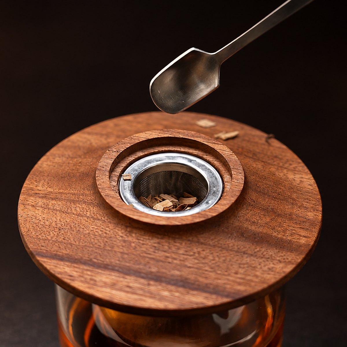 Adding wood chips to a WIBIMEN whiskey smoker