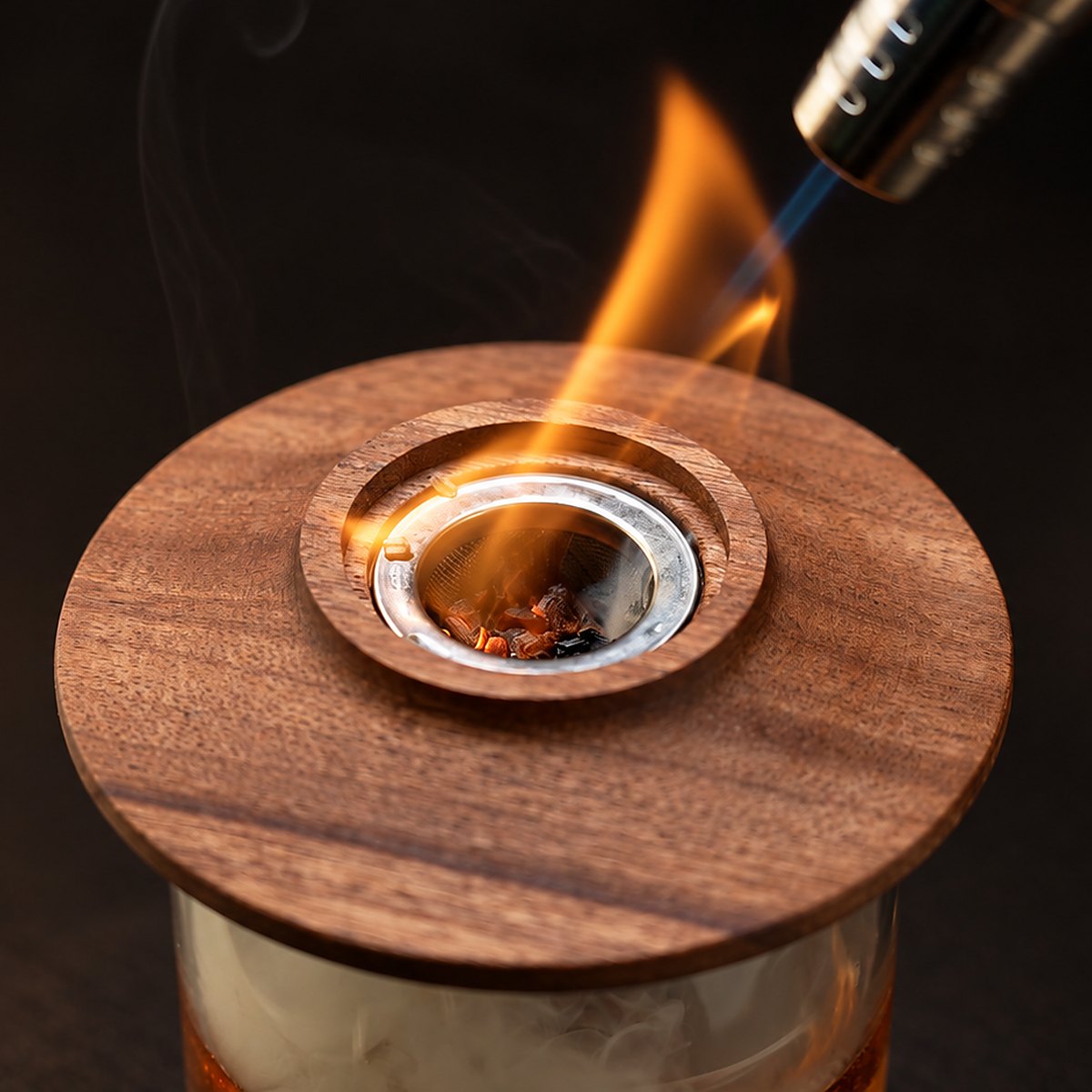Lighting wood chips in a whiskey smoker with a torch
