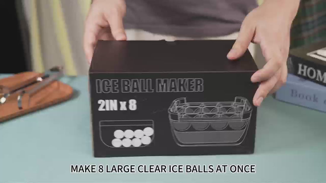 Hands holding a black box for an ice ball maker that makes eight 2-inch clear ice spheres